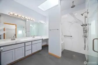 The primary bath has a tiled roll-in shower for wheelchair access