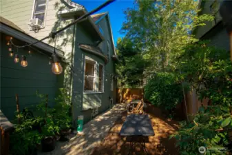 Enclosed side yard with picnic table perfect for entertaining.