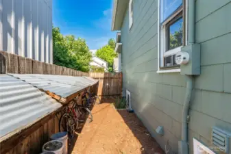 Enclosed side of house has bike storage for students.