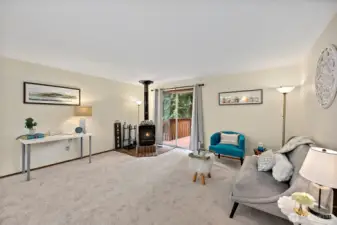 Spacious living room with a woodstove on the corner