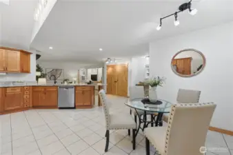 Open concept kitchen with ceramic tile floors, granite countertops, and stainless steel appliances.