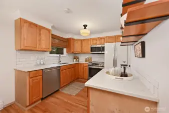 Kitchen with quartz counters, and newer appliances.