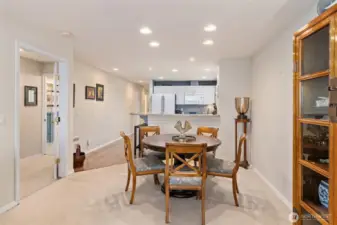 Looking into the dining area, with the primary suite to the left and the kitchen with breakfast bar just ahead, creating an open and intuitive layout ideal for everyday living and entertaining.