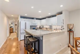 The home welcomes you with a rich hardwood entry that extends down the hallway and into the updated kitchen, creating a seamless and elegant flow. Just imagine friends and loved ones gathered around the kitchen during holidays and special occasions, sharing laughter, meals, and memories in this inviting space.