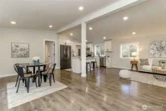 This view of the kitchen and dining room was taken from the front door. Primary bedroom to the left of the fridge.