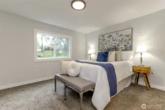 Primary bedroom overlooks front yard.