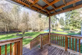 Back covered porch area overlooking the backyard. Another outbuilding for storage, chickens, dog house or???