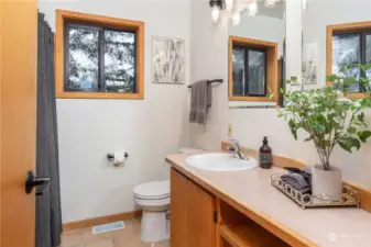 A full bath with shower over tub sits between the two bedrooms on the main floor.