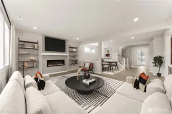 Open concept, great room with fireplace, formal dining area, and large windows for natural light. Photo is of actual home virtually staged.
