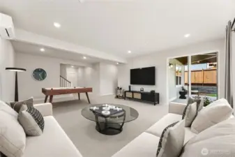 Huge rec room on lower level. Covered patio area. Movie room, playroom, game room, lots of options. Photo of actual home with virtual staging.