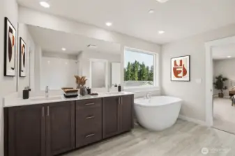 Primary bedroom 5-piece bathroom with freestanding soaker tub. Photo of actual home with virtual staging.
