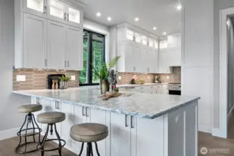 Well lit kitchen with under and upper cabinet lighting.