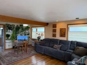 Open-concept living room with french doors lots of large windows facing the views,hardwood flooring with light and bright colors greet you in the happy home