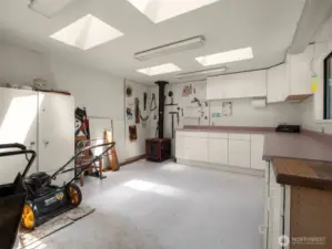 Fantastic shop space with wood stove and skylights.