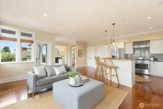 Note the door to the deck off to the left. Kitchen with many newer appliances to the right. The doors near the kitchen are for the pantry. Tons of storage! In front of the pantry doors is a perfect spot for a round dining table.