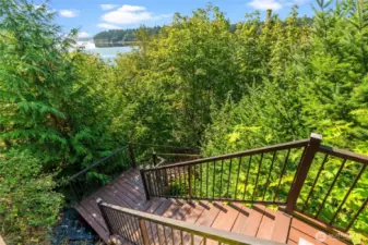 Custom designed stairs, featuring easy care composite decking treads, lead to your private beach!
