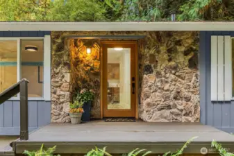 Welcoming entry framed in natural stone sets a warm and inviting tone from the moment you arrive!