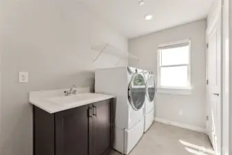 Laundry room with utility sink, washer & dryer are an option.