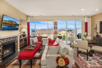 Living room area with Cascade Mountain view and cozy gas fireplace.
