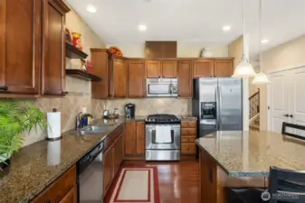 Slab granite surfaces and tile backsplash.