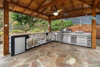 Outdoor kitchen with granite countertops.  For grilling in all types off weather!