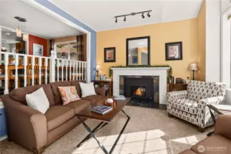 Warm and inviting living room off the entryway with gas fireplace