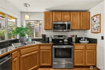 Glass tile backsplash and updated pendants complete the contemporary look.