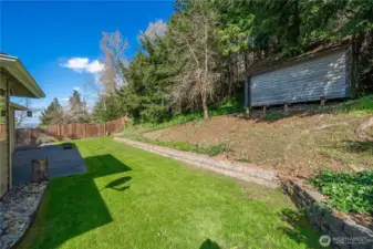 Roomy backyard is fully landscaped.  Shed stays!