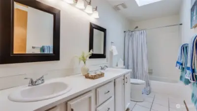 Full guest bath upstairs with double sink vanity & shower/tub combo. Plus new skylight installed in 2021!