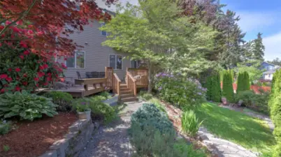You will love the year round beauty of this multi-level yard, from the deck to the lower grassy portion with patio and everything in between!