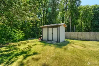 Storage shed stays! Perfect spot for garden tools, mowers and fuel storage.