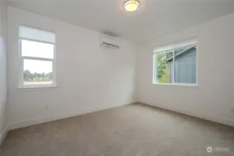 The third upstairs Bedroom mirrors the second with its carpeted floors, generous closet space, and a mini-split heating and cooling system.