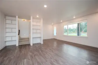 Attractive Luxury Vinyl Plank flooring, abundant recessed lighting & modern fixtures are found throughout the Main Floor. The Smart Home Center to the right of the stairway features built-in shelves & a data port. The Smart Home tablet serves as the home base for the Home Automation Suite. (video doorbells, lighting, thermostats, door locks & voice control functionality).