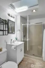 Private ¾ primary bath with skylight and walk-in shower.