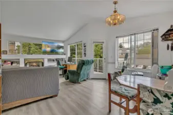 Spacious living room with cozy fireplace opens to your own private patio
