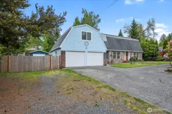 Front of home, extra parking & RV parking behind fence.