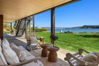 Completely covered ground level aggregate concrete patio runs the entire length of the house!