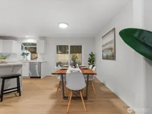 Open dining areas with seamless flow to the kitchen and new sliding door access to the backyard for easy indoor-outdoor living