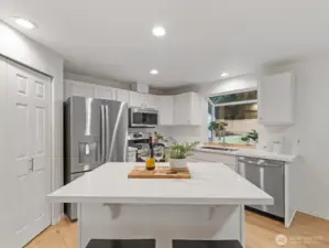 Kitchen pantry space with island seating and plenty of cupboards and countertop space