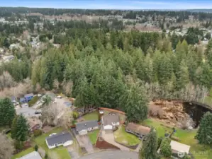 Aerial view highlighting the home's location, expansive lot, and private serene setting