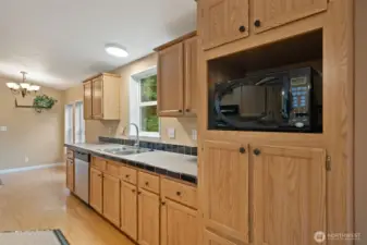 Gally Kitchen with serving or breakfast bar. Adjacent to dining room and a flex room. Walk-in pantry and laundry are adjacent the flex room in this photo.