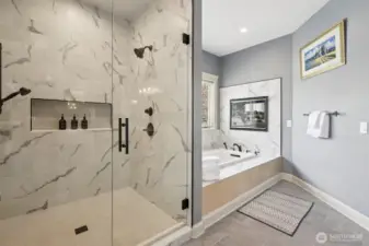 Primary bathroom showcasing a custom tiled walk-in shower with glass enclosure and a separate soaking tub. Thoughtfully designed with quality finishes, updated fixtures, and a functional layout that offers both style and everyday comfort.
