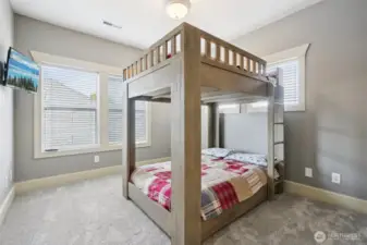 Bright secondary bedroom offering flexible use, featuring ample natural light, soft neutral finishes, and a layout well suited for guests, children, or home office needs. Comfortable proportions allow for a variety of furniture configurations.
