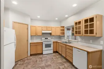 Roomy kitchen with new range and dishwasher.