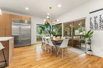 Classic midcentury light fixture above the dining table.  Huge glass slider opens to the covered front porch.