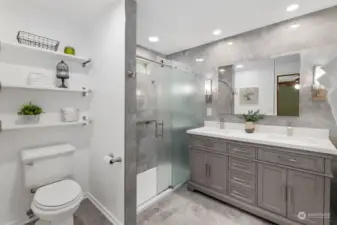 Tall double vanity, lovely sconce lighting, tile floor, wall shelves, and fabulous shower--perfect way to begin and end the day!