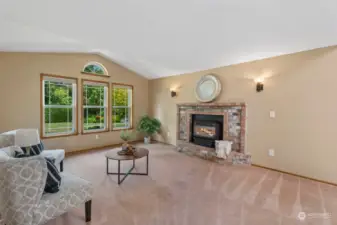 Brick surrounded gas fireplace is set on thermostat for convenience, adding ambiance and warmth.