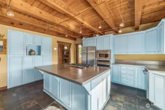 Stainless steel counters compliment the natural wood ceilings. Large pantry hiding just off the kitchen along with an enclosed exterior breakfast nook porch.