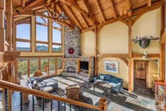 Breathtaking... Enjoy the SE views of local foothills and the sweeping 20 acres that lead down to the Nisqually River. Real wood stone fireplace and accent lighting in the rafters bring so much warmth to this home.