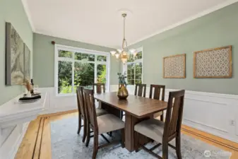 Formal dining room with hardwood floors can easily accommodate a larger table.